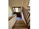 A carpeted staircase leading to a wooden front door with diamond-shaped glass panes at 4152 Scenic Mountain Dr, Snellville, GA 30039