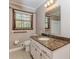 Bathroom with granite countertop, white cabinets and large mirror provides a bright area at 1152 Old Coach Rd, Stone Mountain, GA 30083