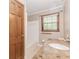 Bathroom showing large window with a white sink and combination tub and shower unit at 1152 Old Coach Rd, Stone Mountain, GA 30083