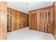 Bedroom with wood paneling, large windows and white tile floors at 1152 Old Coach Rd, Stone Mountain, GA 30083