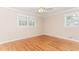 Bedroom with a ceiling fan, hardwood floors and large windows at 1152 Old Coach Rd, Stone Mountain, GA 30083
