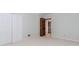 Bedroom with neutral carpeting, double door closet, and wood door, providing ample space at 1152 Old Coach Rd, Stone Mountain, GA 30083