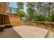 Spacious wooden deck featuring railings and bench seating overlooking a wooded area at 1152 Old Coach Rd, Stone Mountain, GA 30083