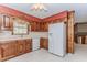 Traditional kitchen with white appliances, tile floor and wallpaper border at 1152 Old Coach Rd, Stone Mountain, GA 30083