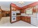 Traditional eat-in kitchen with white tile floors and view of the Gathering room at 1152 Old Coach Rd, Stone Mountain, GA 30083