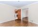 Bright living room with hardwood floors, neutral paint, and views into the kitchen and living room at 1152 Old Coach Rd, Stone Mountain, GA 30083