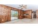 Living room with wood paneling, built-in shelving, and sliding glass doors leading to the deck at 1152 Old Coach Rd, Stone Mountain, GA 30083