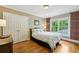 Cozy bedroom with hardwood floors, a window with backyard views, and double door closet at 2726 Mabry Ne Rd, Atlanta, GA 30319
