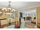 Elegant dining room featuring a vintage chandelier and classic wallpaper that connects to a cozy piano room at 2726 Mabry Ne Rd, Atlanta, GA 30319