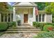 Inviting front entrance with a custom wood door, stone steps, and beautifully maintained shrubbery at 2726 Mabry Ne Rd, Atlanta, GA 30319