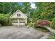 Two-car garage with an abundance of trees and lush plants adding a touch of elegance at 2726 Mabry Ne Rd, Atlanta, GA 30319
