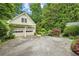 Two-car garage with an abundance of trees and lush plants adding a touch of elegance at 2726 Mabry Ne Rd, Atlanta, GA 30319