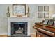 Cozy living room featuring a marble fireplace, piano, and elegant decor at 2726 Mabry Ne Rd, Atlanta, GA 30319