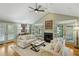 Bright living room features hardwood floors, neutral decor, and fireplace with French doors at 2726 Mabry Ne Rd, Atlanta, GA 30319