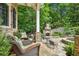 Outdoor patio with comfortable seating, stone fireplace and mature landscaping providing ultimate privacy at 2726 Mabry Ne Rd, Atlanta, GA 30319