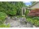 Charming outdoor patio with elegant metal furniture, lush greenery, and a peaceful garden setting, great for entertaining at 2726 Mabry Ne Rd, Atlanta, GA 30319