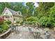 Charming stone patio featuring wrought iron furniture surrounded by lush landscaping at 2726 Mabry Ne Rd, Atlanta, GA 30319