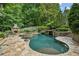 Backyard pool with stone surround, fireplace, spa and lush landscaping for a relaxing retreat at 2726 Mabry Ne Rd, Atlanta, GA 30319