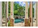 Through the doors: a scenic outdoor oasis with a pristine pool, lush landscaping, and stone features at 2726 Mabry Ne Rd, Atlanta, GA 30319