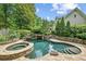 Backyard showcases a custom pool with waterfall feature and stone surround, with spa at 2726 Mabry Ne Rd, Atlanta, GA 30319