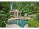 Inviting pool area features a pool house, spa, waterfall, and outdoor fireplace, perfect for entertaining at 2726 Mabry Ne Rd, Atlanta, GA 30319