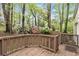 Landscaped backyard featuring a wooden deck and flowering bushes at 3450 Brookhill Cir, Marietta, GA 30062