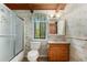 Bathroom with shower, oak vanity, and floral wallpaper at 3450 Brookhill Cir, Marietta, GA 30062