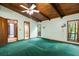 Bedroom with wood ceiling, green carpet, and windows letting in natural light at 3450 Brookhill Cir, Marietta, GA 30062