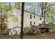 Rear exterior view of a tan house with a wood deck and a two car garage in a wooded area at 3450 Brookhill Cir, Marietta, GA 30062
