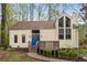 Single-Gathering home boasting a charming exterior with a blue front door, complemented by lush landscaping at 3450 Brookhill Cir, Marietta, GA 30062