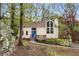 Charming single-Gathering home with a blue front door, surrounded by lush trees and landscaping at 3450 Brookhill Cir, Marietta, GA 30062
