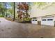 View of the two-car garage with stone accents and a spacious concrete driveway leading to the house at 3450 Brookhill Cir, Marietta, GA 30062
