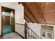 Upstairs hallway with wood railing leading down to the front door, with wood ceiling beams at 3450 Brookhill Cir, Marietta, GA 30062