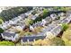 An aerial view of a residential neighborhood shows well-maintained townhomes surrounded by lush greenery and mature trees at 5213 Pinnacle Point Ct, Norcross, GA 30071
