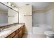 Bathroom featuring double sinks, granite counters, tub-shower combo and tile flooring at 5213 Pinnacle Point Ct, Norcross, GA 30071