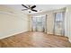 Bedroom featuring wood flooring, floating shelves, ceiling fan and natural light from large windows at 5213 Pinnacle Point Ct, Norcross, GA 30071