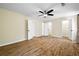 Spacious bedroom features wood flooring, neutral walls, ceiling fan and multiple closets at 5213 Pinnacle Point Ct, Norcross, GA 30071