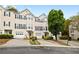 Townhouse exterior with individual garages, blue shutters, and well-kept landscaping at 5213 Pinnacle Point Ct, Norcross, GA 30071