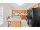 Kitchen with oak cabinets, granite countertops, and black appliances at 5213 Pinnacle Point Ct, Norcross, GA 30071