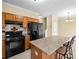 Well-equipped kitchen featuring granite countertops, a black fridge, and modern appliances at 5213 Pinnacle Point Ct, Norcross, GA 30071