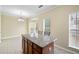 Bright kitchen nook with granite island, tile floors, and natural light from bay windows at 5213 Pinnacle Point Ct, Norcross, GA 30071