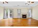 Hardwood floors and fireplace in a living room with double french doors at 5213 Pinnacle Point Ct, Norcross, GA 30071