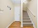 Entryway staircase with beige walls, carpeted stairs and wood flooring at 5213 Pinnacle Point Ct, Norcross, GA 30071