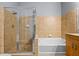 Bathroom featuring glass-enclosed shower, soaking tub, and tiled walls at 711 Cosmopolitan Ne Dr # 213, Atlanta, GA 30324