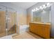 Bathroom with glass shower, soaking tub, and double sink vanity at 711 Cosmopolitan Ne Dr # 213, Atlanta, GA 30324