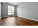 A bedroom featuring hardwood floors and a window bringing in natural light at 711 Cosmopolitan Ne Dr # 213, Atlanta, GA 30324