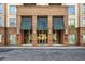 Close up of brick apartment building entrance with covered awning and glass doors at 711 Cosmopolitan Ne Dr # 213, Atlanta, GA 30324