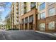 Stately brick apartment building with covered entrance, and multiple balconies on a tree lined street at 711 Cosmopolitan Ne Dr # 213, Atlanta, GA 30324