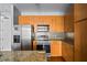 Kitchen boasts stainless steel appliances, wood cabinets, and granite countertops at 711 Cosmopolitan Ne Dr # 213, Atlanta, GA 30324