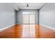Open-concept apartment living room with hardwood floors, neutral paint and large sliding glass doors at 711 Cosmopolitan Ne Dr # 213, Atlanta, GA 30324